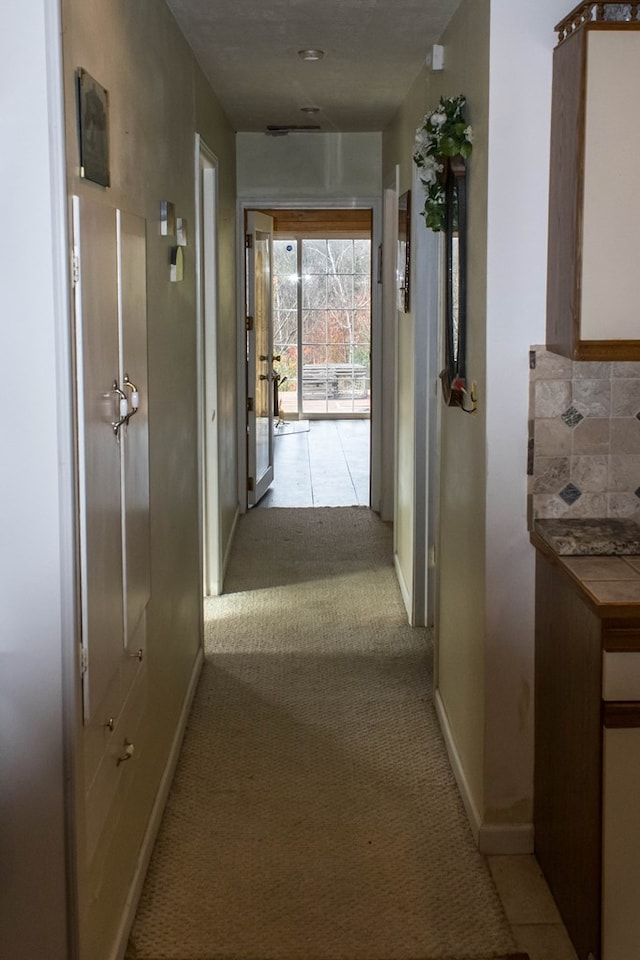 hall featuring light colored carpet