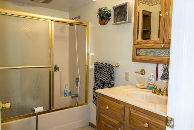 bathroom featuring enclosed tub / shower combo and vanity