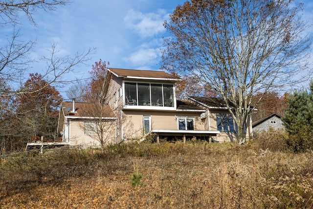 back of house with a sunroom