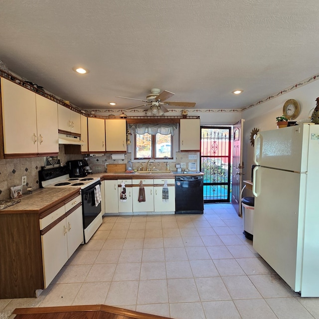 kitchen with tasteful backsplash, ceiling fan, sink, and white appliances