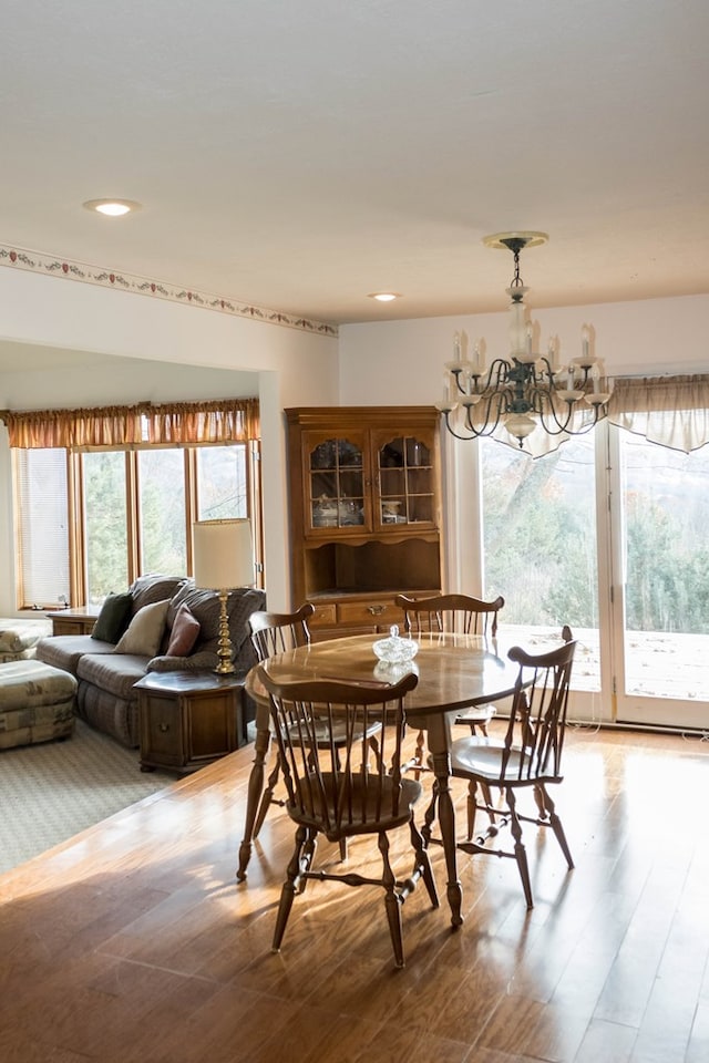 dining space featuring an inviting chandelier and light hardwood / wood-style floors