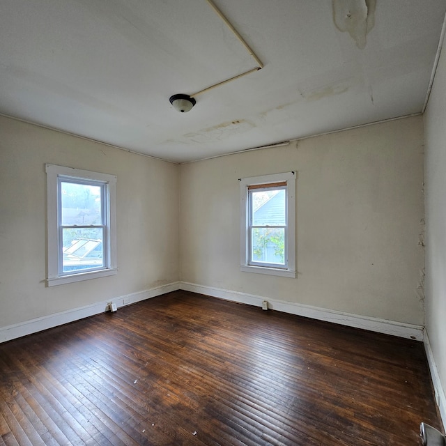 unfurnished room featuring dark hardwood / wood-style floors