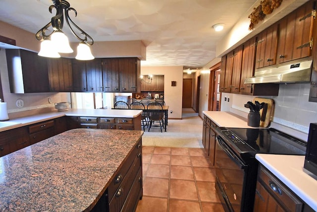 kitchen featuring hanging light fixtures, light tile patterned floors, a notable chandelier, black range with electric stovetop, and backsplash