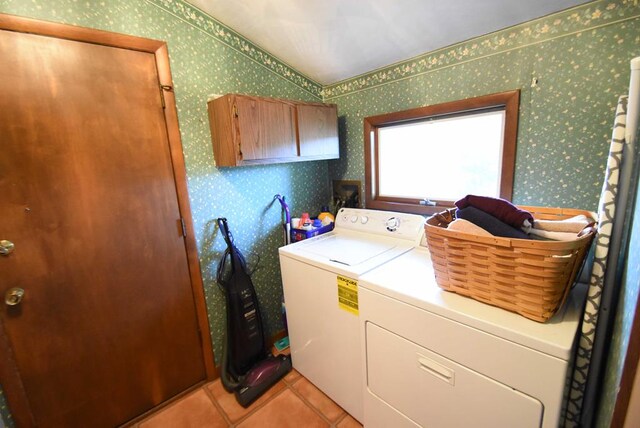 laundry area with light tile patterned floors and washer and dryer