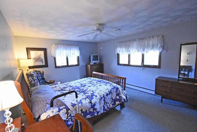 carpeted bedroom with a baseboard heating unit and ceiling fan