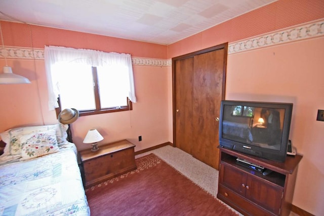 bedroom with carpet floors and a closet