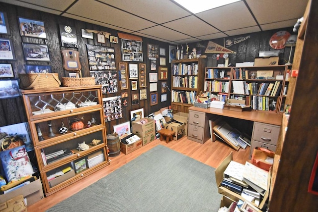 interior space featuring hardwood / wood-style floors and a drop ceiling