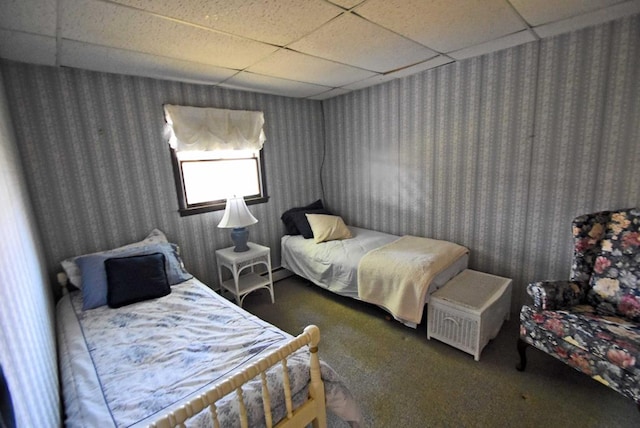 carpeted bedroom featuring a paneled ceiling