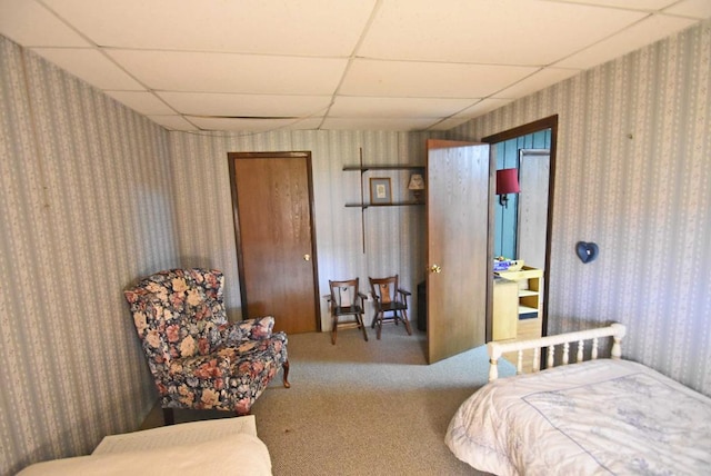 bedroom featuring a paneled ceiling and carpet