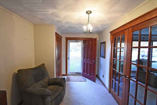 entryway featuring ornamental molding, carpet flooring, an inviting chandelier, and french doors