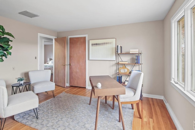 office area with light hardwood / wood-style floors