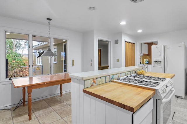 kitchen featuring decorative light fixtures, white appliances, white cabinetry, and a kitchen island