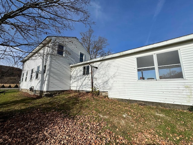 view of property exterior with a lawn