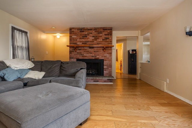 living room with a fireplace and light hardwood / wood-style flooring