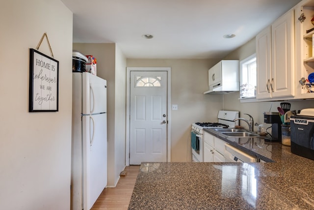 kitchen featuring white cabinetry, a healthy amount of sunlight, white appliances, and light hardwood / wood-style floors