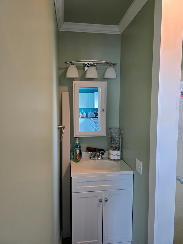 bathroom featuring crown molding and vanity