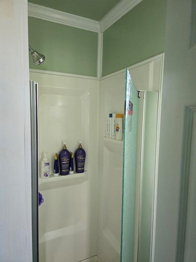 bathroom featuring a shower and crown molding