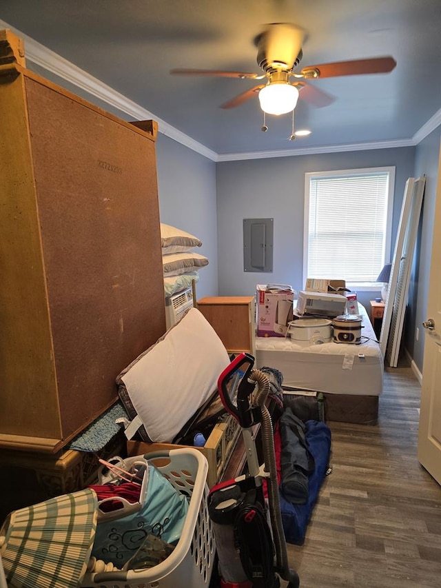 bedroom with electric panel, hardwood / wood-style flooring, ceiling fan, and crown molding