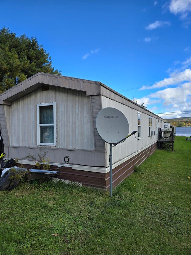 view of property exterior with a yard and a water view