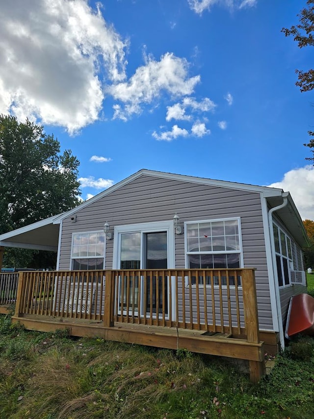 back of house featuring a wooden deck