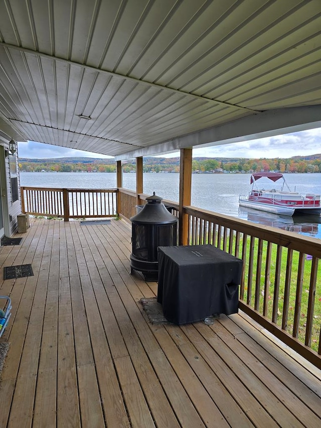 wooden terrace featuring a water view