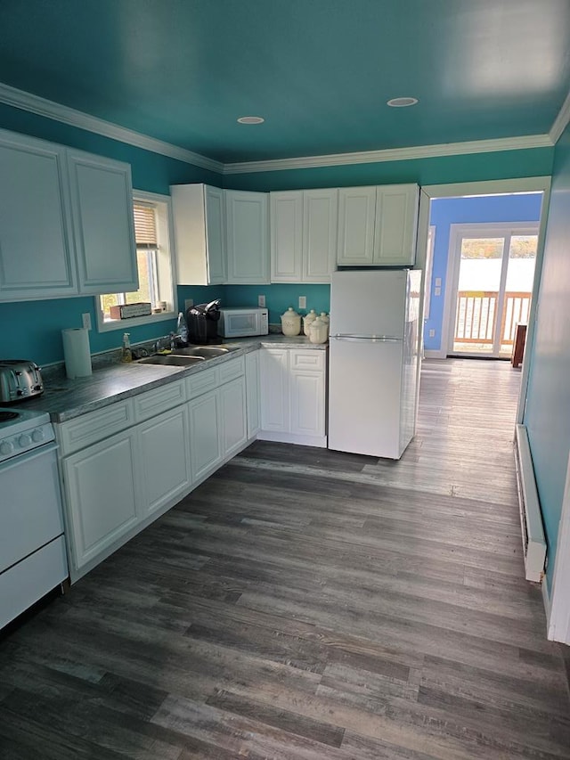 kitchen with dark hardwood / wood-style flooring, white appliances, and white cabinetry