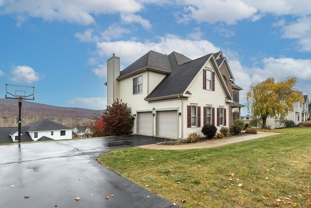 view of side of home with a lawn and a garage