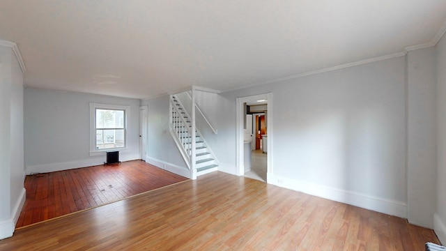 empty room with hardwood / wood-style flooring and ornamental molding