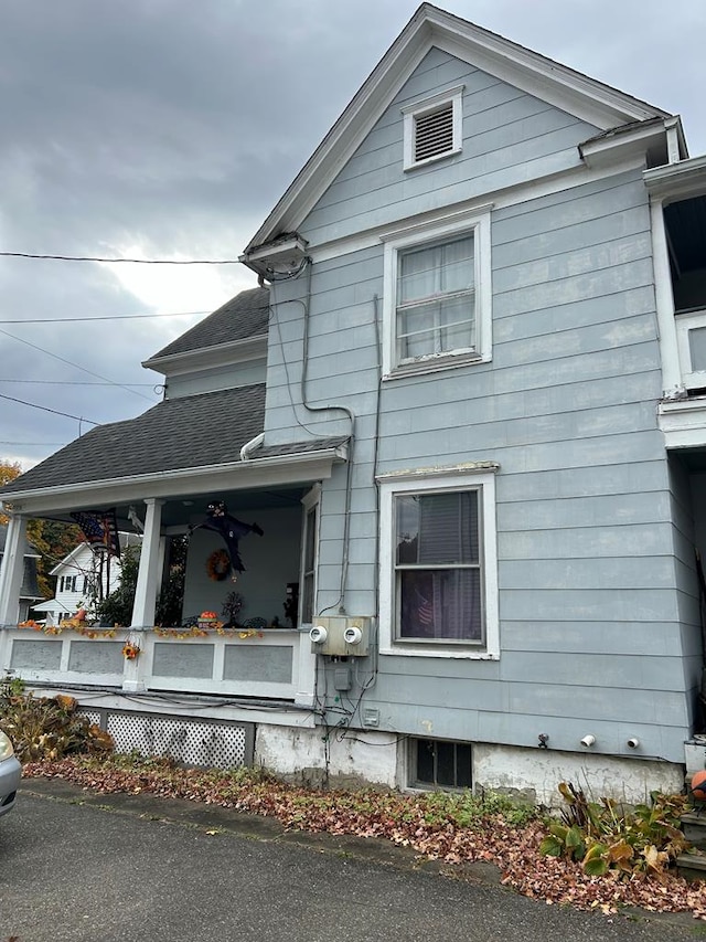 view of property exterior featuring covered porch