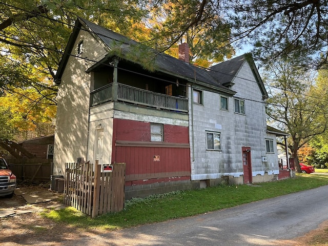 view of side of home with a balcony