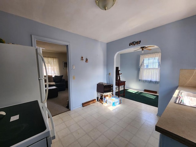 interior space with ceiling fan and sink