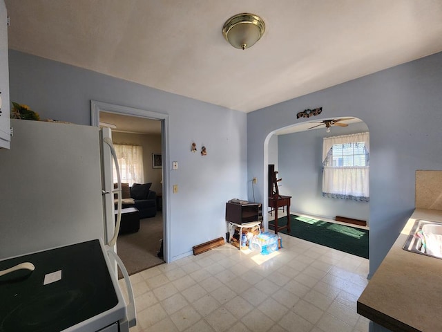 interior space featuring ceiling fan and sink