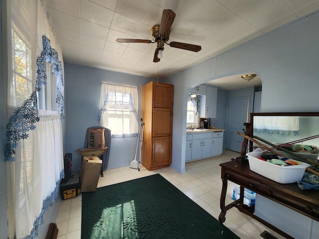 interior space featuring ceiling fan and sink