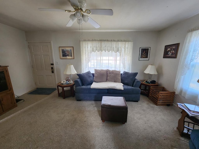 carpeted living room with ceiling fan