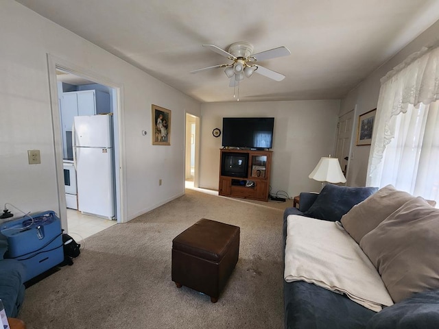 living room with a wealth of natural light, light colored carpet, and ceiling fan