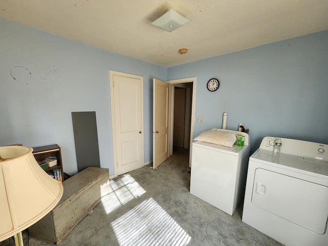 washroom with washer and dryer and light colored carpet