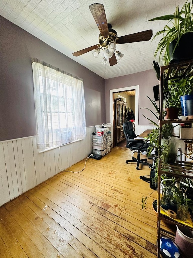 home office with light hardwood / wood-style floors