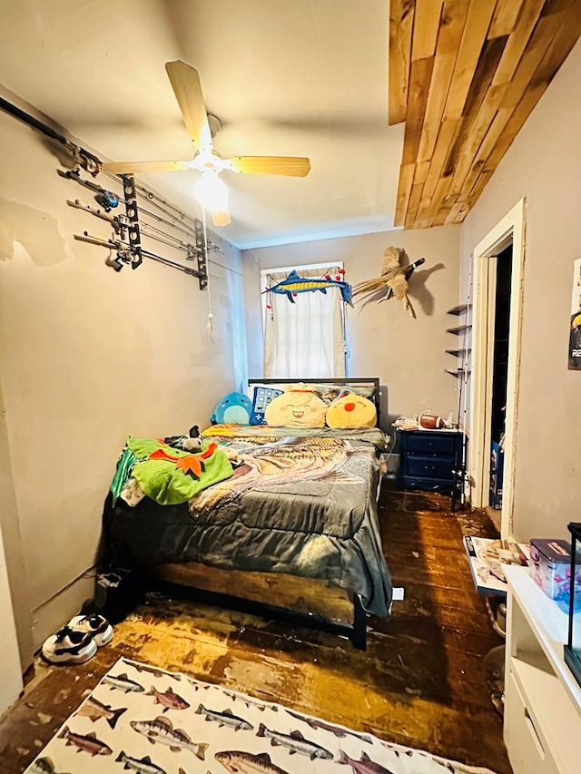 bedroom with ceiling fan and dark hardwood / wood-style floors