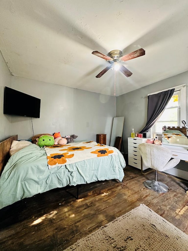 bedroom with ceiling fan and hardwood / wood-style floors