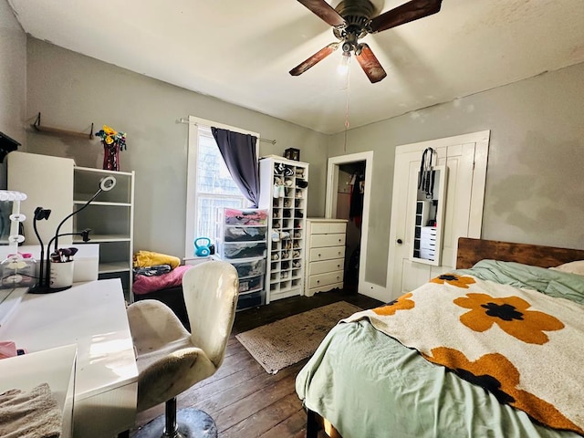 bedroom with ceiling fan and dark wood-type flooring