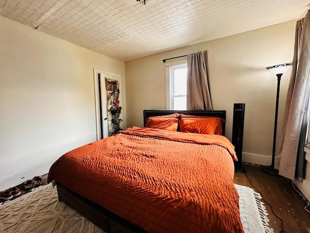 bedroom featuring dark wood-type flooring