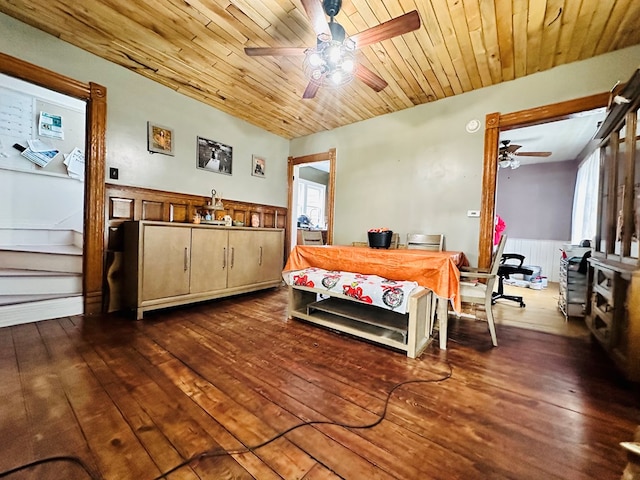 bedroom with ceiling fan, dark hardwood / wood-style flooring, and wooden ceiling