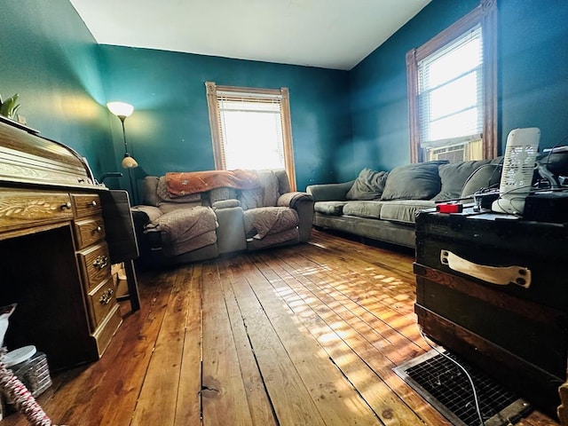 living area featuring hardwood / wood-style floors and a healthy amount of sunlight