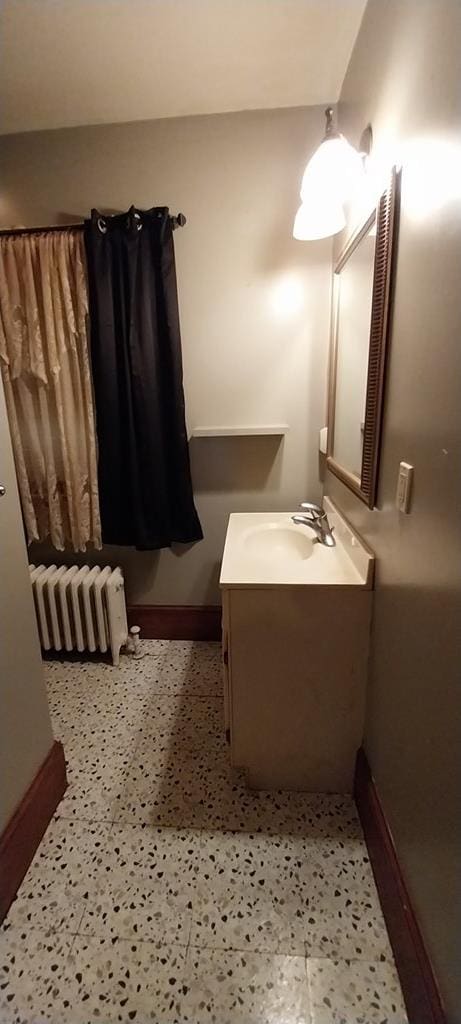 bathroom with radiator and vanity