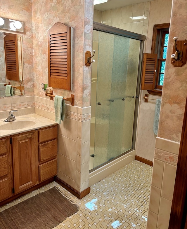 bathroom featuring vanity, a shower with door, and tile patterned flooring