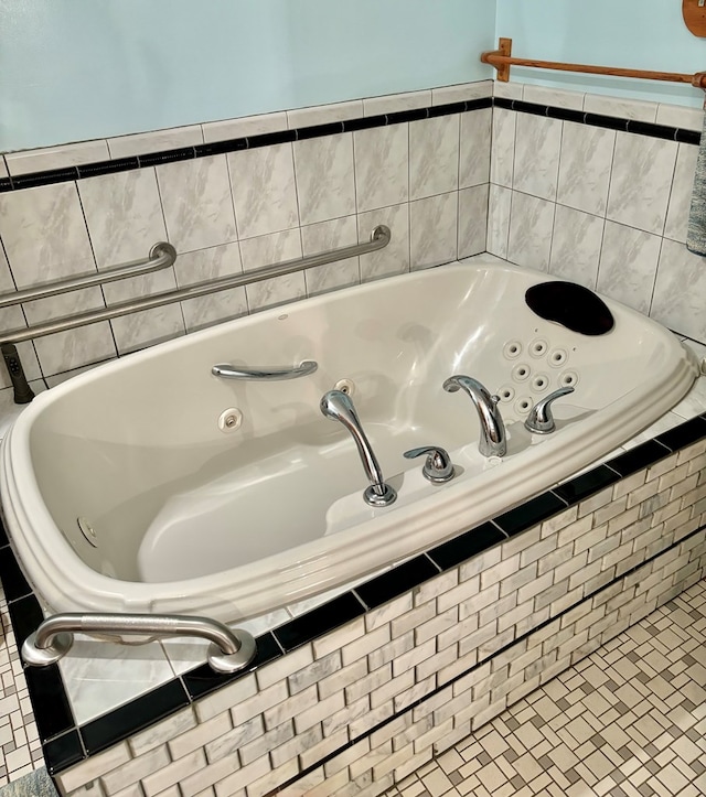 bathroom featuring tile patterned flooring and tiled tub