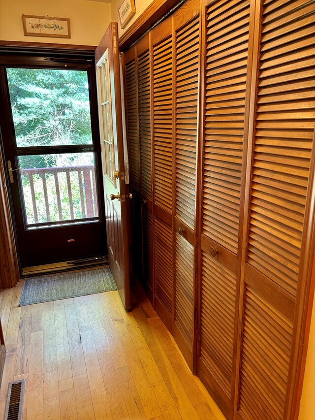 doorway to outside with light wood-type flooring