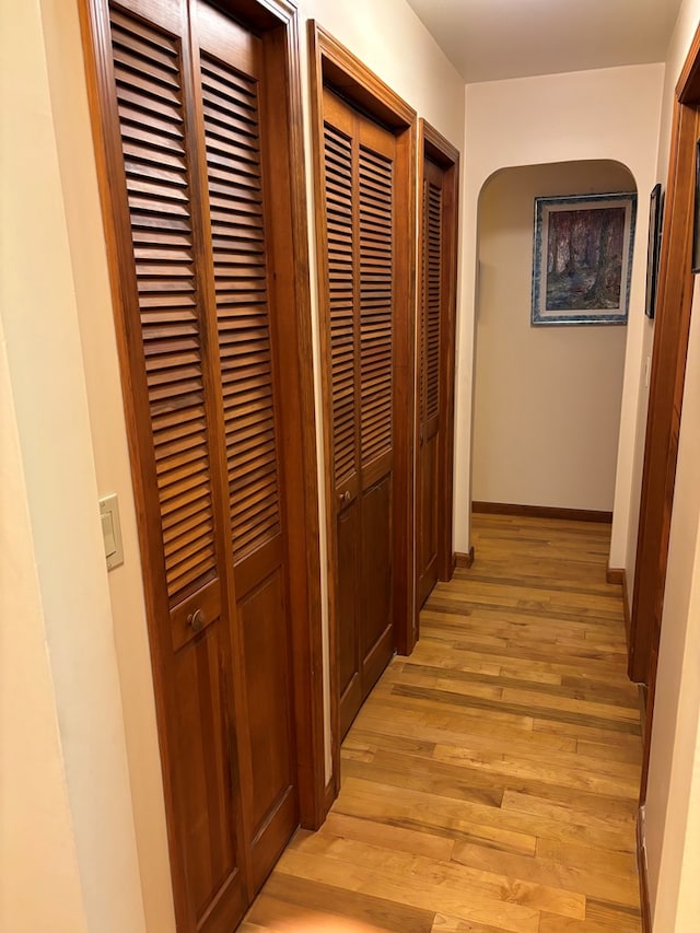 corridor with light hardwood / wood-style floors