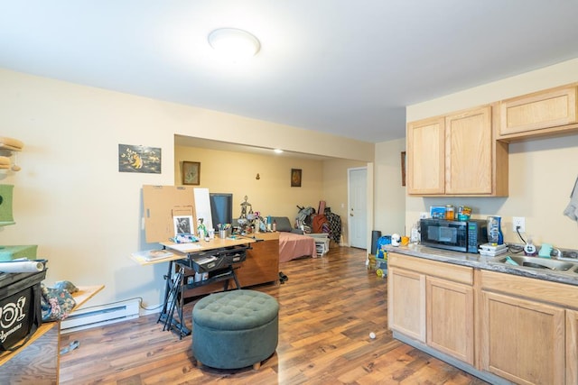 kitchen featuring light brown cabinets, hardwood / wood-style flooring, and baseboard heating