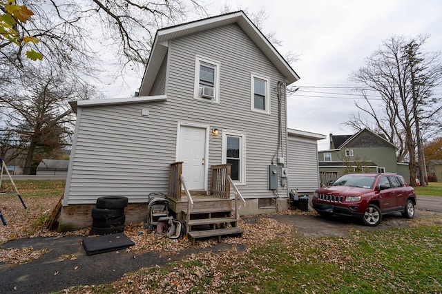 rear view of house with cooling unit